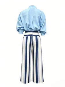 Detail view of casual two-piece set, light blue top and striped wide-leg pants, comfy style.