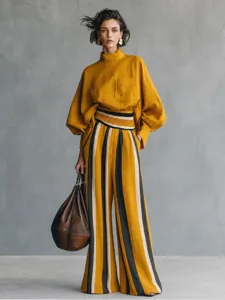 Elegant mustard yellow women's two-piece set featuring a long-sleeve top and striped wide-leg pants.