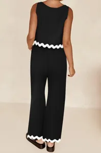 Back view detail of black sleeveless two-piece set with white scalloped hem and wide leg pants.