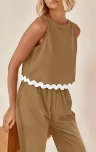 Detail shot of women casual sleeveless top with white scalloped hem and matching brown pants.