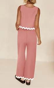 Pink two-piece casual set with a sleeveless top and wide-leg pants featuring white scalloped trim.