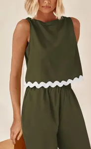 Detail shot of women green sleeveless crop top with white scalloped hem casual two piece set.