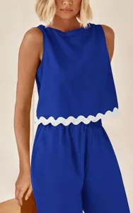 Blue sleeveless crop top with white scalloped hem and matching casual pants detail view.