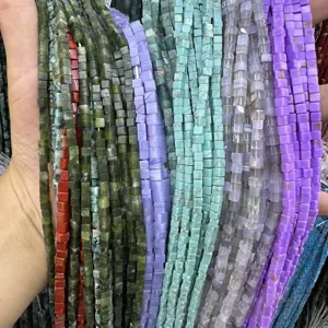 Detailed macro view of 3x3mm natural stone square beads in various colors for DIY crafts