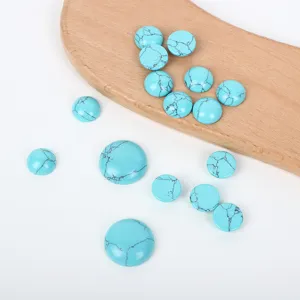 Detailed view of round turquoise cabochons in various sizes with black matrix patterns