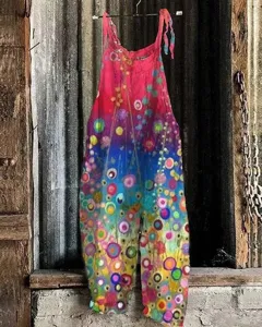 Close-up detail of colorful printed cotton linen strap jumpsuit showing abstract floral pattern.