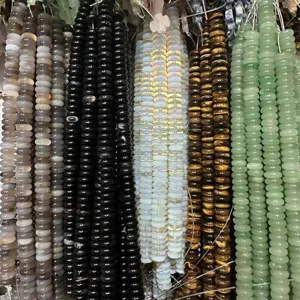 Detailed view of 4x10mm natural stone spacer beads in various colors for DIY jewelry.