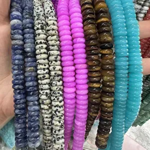 Macro detail of various colorful 4x10mm natural stone spacer beads rows