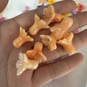 Top-down detail shot of peach-colored flower-shaped beads held in hand.