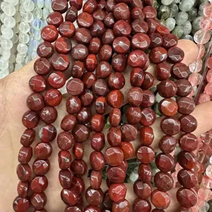 Macro close-up view of dark red faceted natural stone disc beads for DIY jewelry making projects