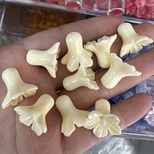 Close-up of cream trumpet flower shell powder beads for DIY jewelry making