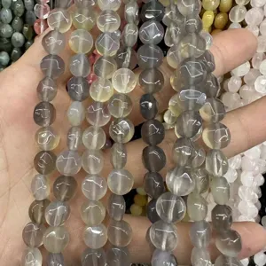 Close-up of disc-cut natural stone beads in grey and yellow for jewelry DIY projects.