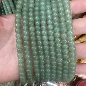 Close-up of light green natural stone barrel loose beads for DIY jewelry making