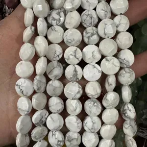 Close-up view of white howlite faceted round disc beads with natural grey marble textures for DIY