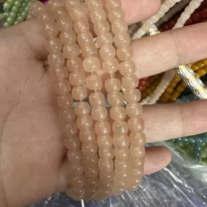 Detail view of peach-colored natural stone barrel beads for DIY jewelry crafting accessories