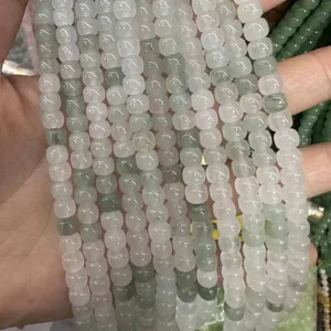 Close-up detail of light green translucent natural stone barrel beads for DIY jewelry
