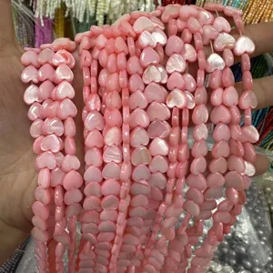 Detailed macro view of pink heart-shaped mother of pearl shell beads for DIY jewelry design
