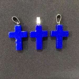 Detailed view of three natural lapis lazuli stone cross pendants for jewelry making