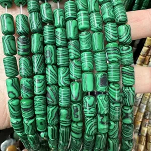 Macro detail of cylindrical green malachite pattern natural stone beads for DIY jewelry
