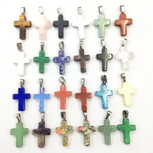 Variety of natural stone cross pendants including rose quartz and aventurine
