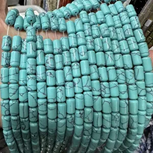 Macro detail of turquoise-colored cylinder stone beads with black matrix for DIY jewelry