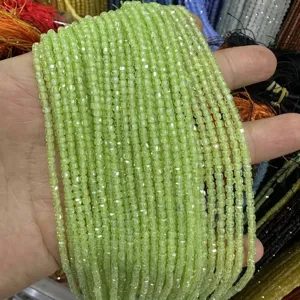 Detailed close-up view of light green faceted square zircon beads for DIY jewelry