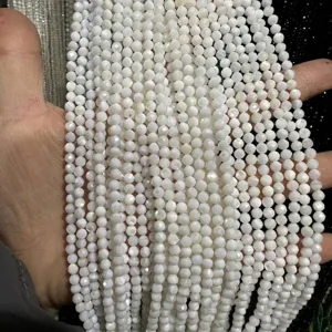 Close-up detail of cream white faceted natural stone beads for DIY necklace and bracelet crafting.