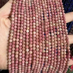 Close-up of faceted pink natural stone beads strand for DIY jewelry making and craft projects