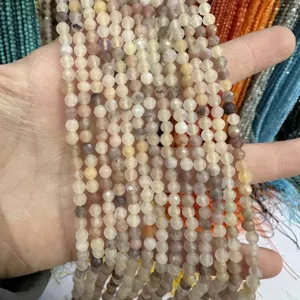 Close-up of faceted natural stone beads in assorted pastel colors for DIY jewelry making