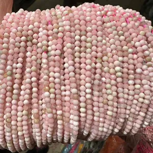 Detailed macro view of pink faceted natural stone beads for DIY jewelry creation.