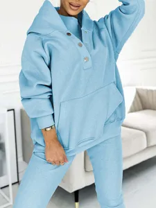 Light blue three piece tracksuit detail, cozy hoodie with snap buttons and ribbed pants.