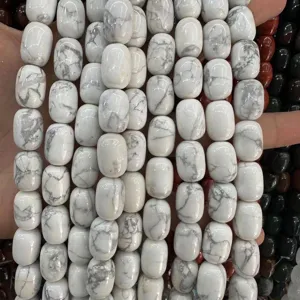 Close-up of white turquoise barrel beads with natural grey marble texture for DIY jewelry