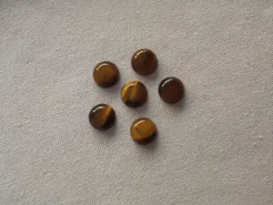 Close-up of natural tiger's eye round cabochons with flat back for DIY jewelry making