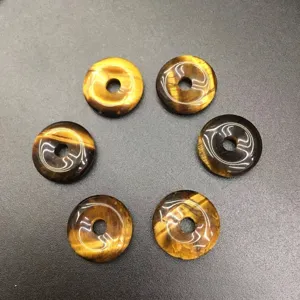 Macro view of 15mm natural tiger eye stone donut pendants for DIY jewelry making