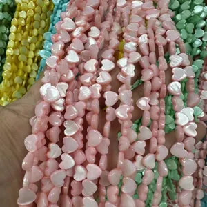 Close-up of iridescent heart-shaped mother of pearl shell beads for DIY jewelry making
