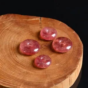 Macro view of natural strawberry crystal ping'an kou beads on a wooden background