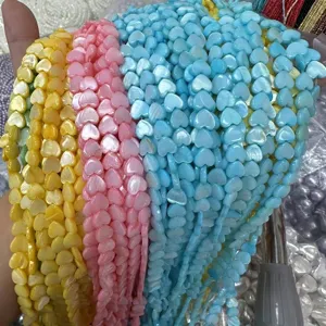 Close-up of colorful heart-shaped mother of pearl beads for jewelry making