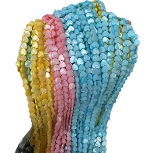 Colorful mother-of-pearl heart beads in pink, yellow, and blue for DIY jewelry crafts