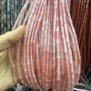 Close-up view of pink translucent 4x9mm tube-shaped natural stone beads for DIY jewelry