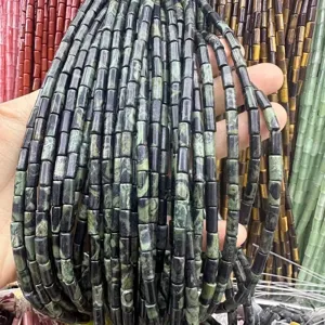 Close-up of 4x9mm green and black cylinder natural stone beads strands for DIY jewelry