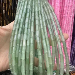 Macro view showing 4x9mm light green natural stone tube beads for DIY jewelry accessory making.