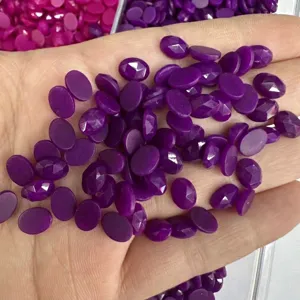Primo piano di pietre preziose ovali sfaccettate viola per gioielli fai-da-te