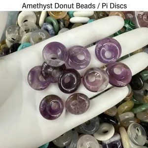 Detailed close-up of natural purple amethyst donut beads for DIY handmade jewelry making