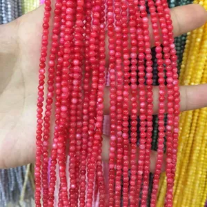 Detailed view of 3mm vibrant red round shell beads for DIY jewelry and crafting projects