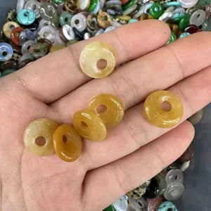 Close-up of yellow natural stone agate eccentric hole donuts for DIY jewelry making