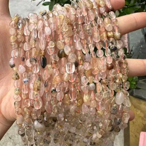 Detailed view of natural 4x6mm irregular rutilated quartz beads for DIY jewelry making.