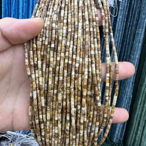 Macro detail of 2x2mm natural agate and tiger eye stone tube beads for DIY jewelry