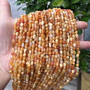 Close-up of irregular natural carnelian stone beads strand for DIY jewelry making