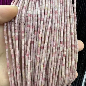 Macro detail of 2x2mm pink natural stone tube beads for DIY jewelry making.