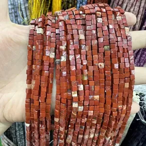 Macro detail of 3x3mm red natural stone cube beads for DIY jewelry making and bracelets